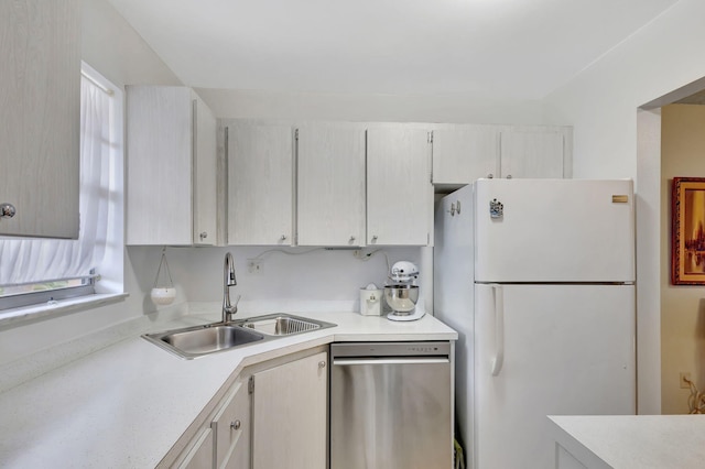 kitchen with white fridge, dishwasher, and sink