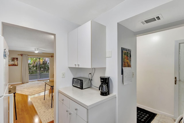 kitchen featuring white cabinets