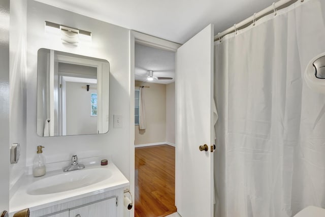 bathroom featuring ceiling fan, hardwood / wood-style floors, and vanity