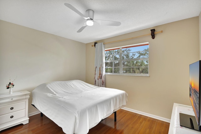 bedroom with ceiling fan and wood-type flooring