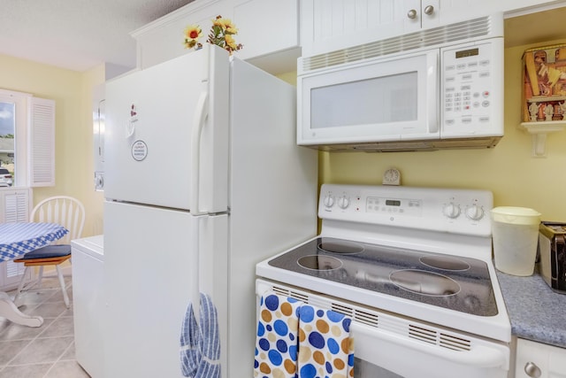 13735 Flora Pl Unit C, Delray Beach, FL 33484 - kitchen with white appliances, white cabinets, and light tile patterned floors