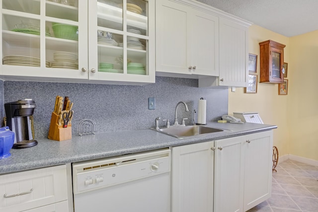 13735 Flora Pl Unit C, Delray Beach, FL 33484 - kitchen featuring dishwasher, a sink, decorative backsplash, white cabinetry, and light countertops