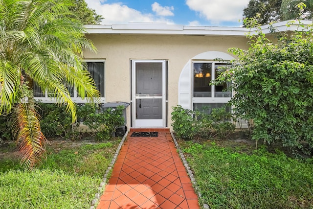 13735 Flora Pl Unit C, Delray Beach, FL 33484 - doorway to property with stucco siding