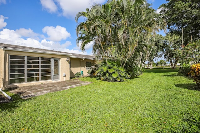 13735 Flora Pl Unit C, Delray Beach, FL 33484 - view of green lawn featuring a patio area