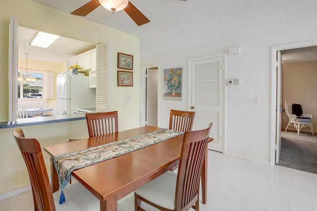 13735 Flora Pl Unit C, Delray Beach, FL 33484 - dining area featuring ceiling fan, a chandelier, and baseboards