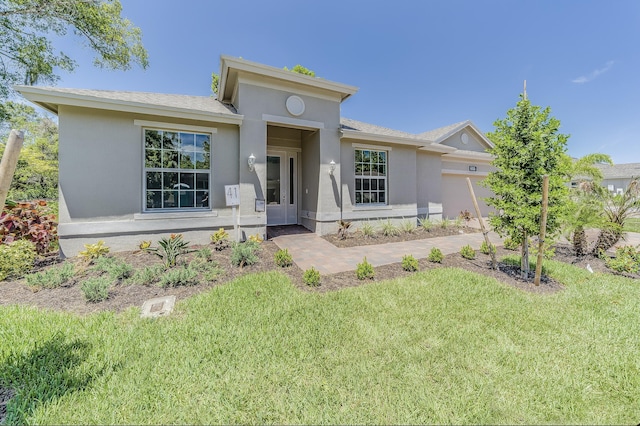 view of front of house featuring a garage and a front yard