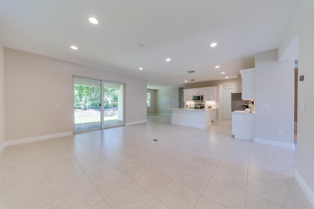 unfurnished living room with light tile patterned flooring