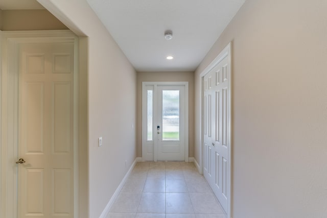 entryway with light tile patterned floors