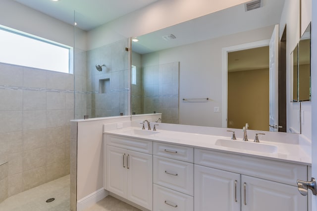 bathroom featuring vanity and a tile shower