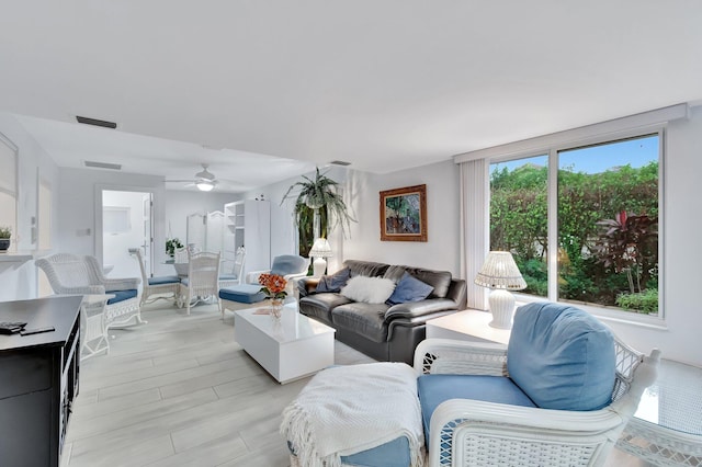 living room featuring light wood-type flooring and ceiling fan