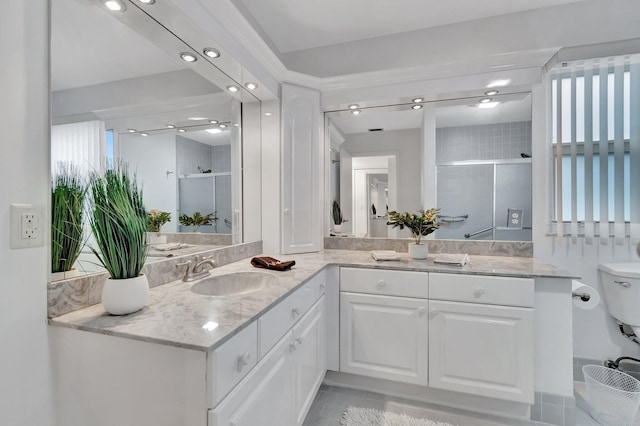 bathroom with vanity and a shower with shower door