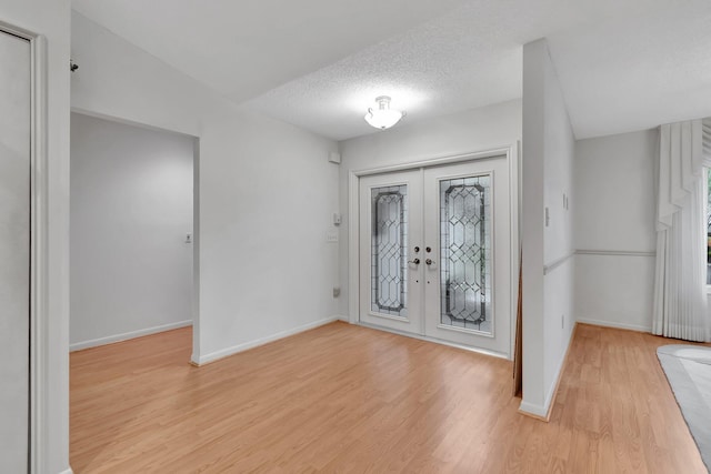 3140 NW 15th St, Delray Beach, FL 33445 - foyer with french doors, light wood-style floors, and a textured ceiling