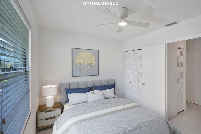 bedroom featuring a textured ceiling and ceiling fan