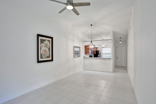 unfurnished living room with light tile patterned floors, ceiling fan with notable chandelier, and a textured ceiling