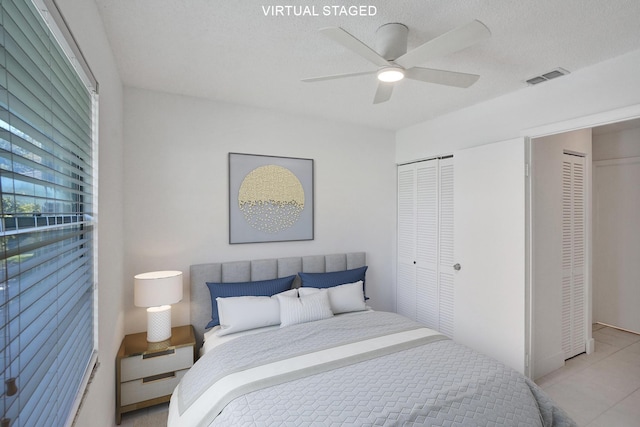 1701 Sabal Ridge Cir Unit G, Palm Beach Gardens, FL 33418 - bedroom featuring light tile patterned floors, a ceiling fan, and two closets