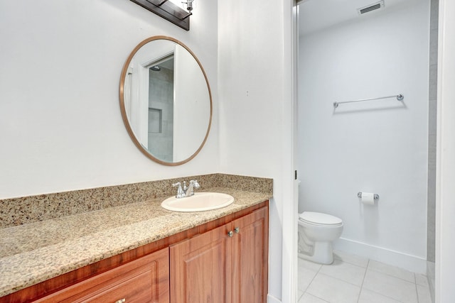 bathroom featuring tile patterned floors, vanity, and toilet