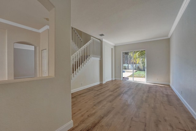 unfurnished room featuring crown molding and light wood-type flooring