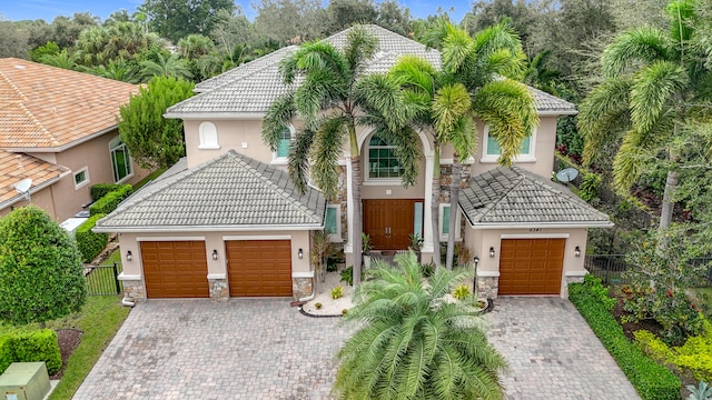 mediterranean / spanish-style house with a garage