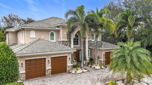 mediterranean / spanish home featuring a garage