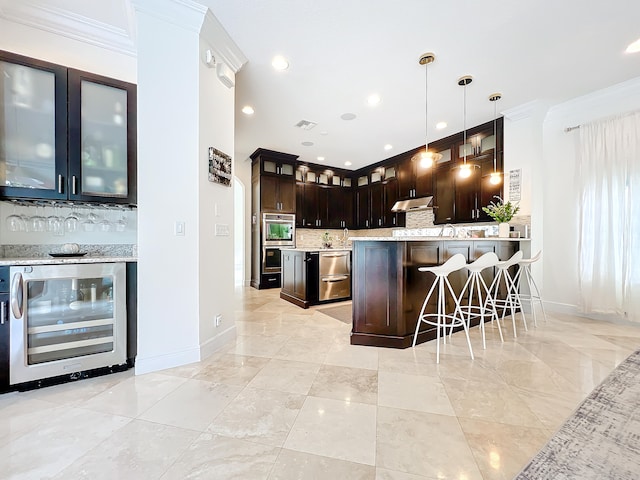 kitchen with pendant lighting, dark brown cabinetry, ornamental molding, and wine cooler