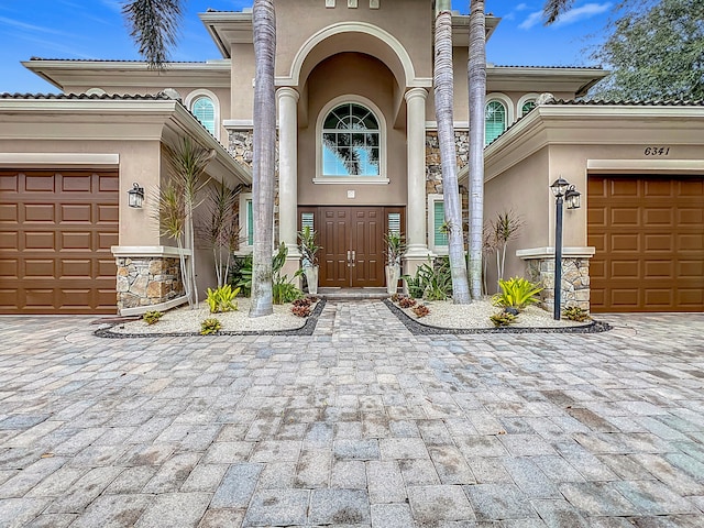 view of exterior entry with a garage