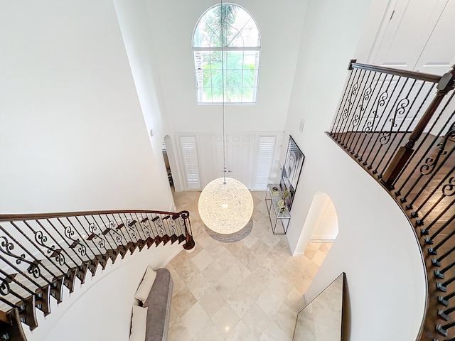 staircase with a towering ceiling