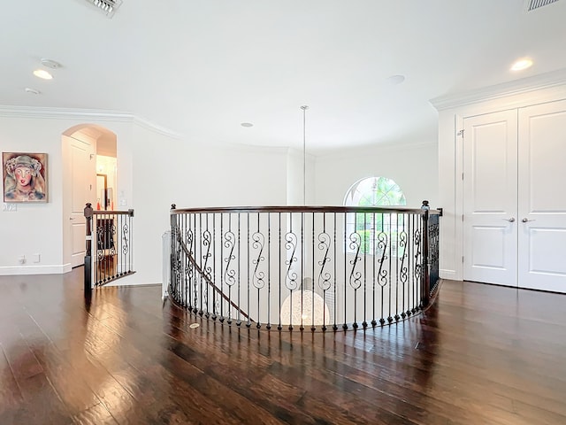 corridor with dark hardwood / wood-style floors and crown molding