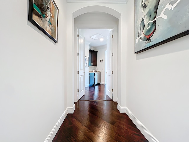 corridor with ornamental molding and dark hardwood / wood-style floors