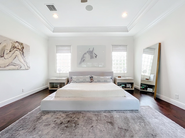 bedroom featuring a tray ceiling, multiple windows, dark hardwood / wood-style floors, and crown molding