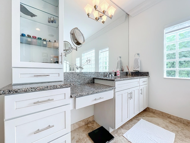 bathroom featuring plenty of natural light, vanity, and crown molding