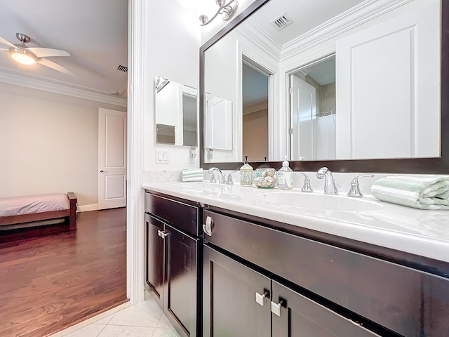 bathroom with ceiling fan, wood-type flooring, vanity, and crown molding