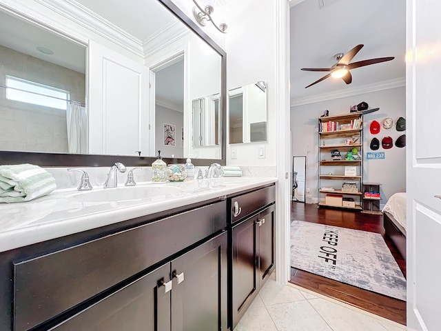 bathroom featuring ceiling fan, wood-type flooring, vanity, and crown molding