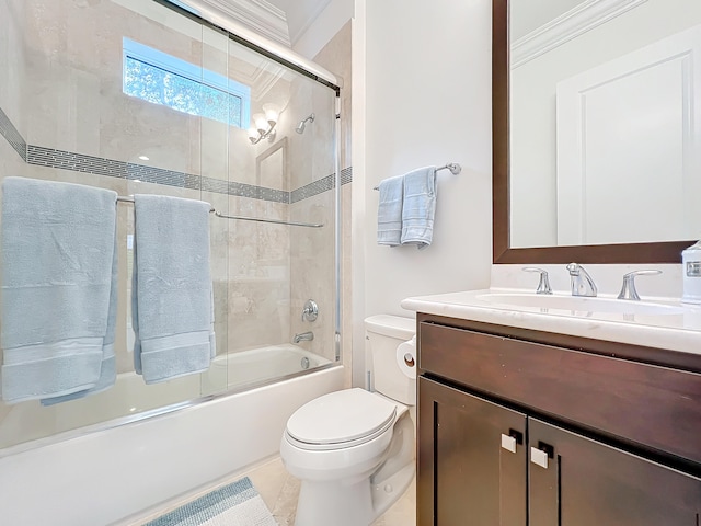 full bathroom with shower / bath combination with glass door, ornamental molding, vanity, tile patterned flooring, and toilet