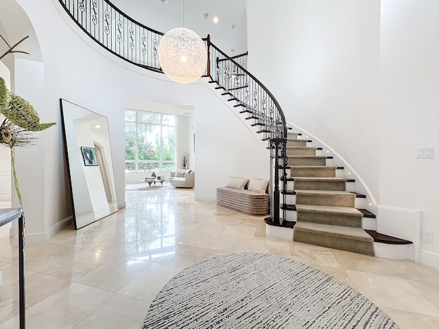 stairway featuring a high ceiling