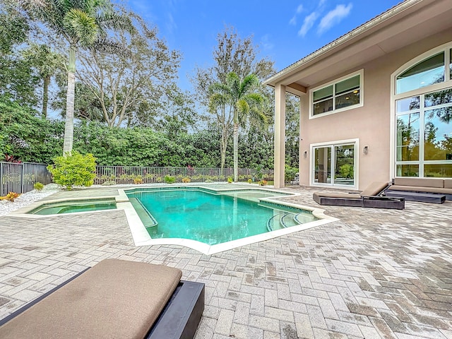 view of swimming pool with a patio and an in ground hot tub