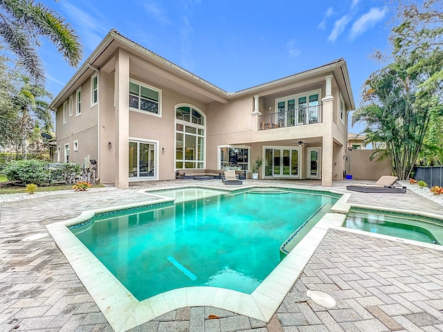 exterior space featuring a patio and an in ground hot tub