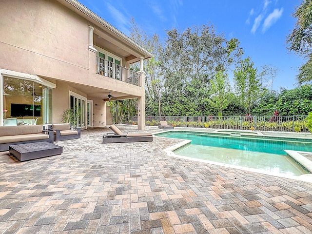 view of swimming pool featuring ceiling fan and a patio