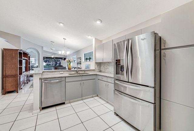 kitchen featuring kitchen peninsula, stainless steel appliances, a wealth of natural light, and sink