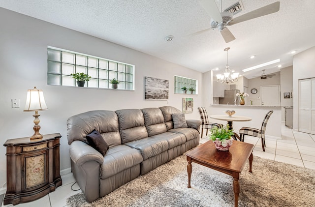 tiled living room featuring ceiling fan with notable chandelier, a textured ceiling, and lofted ceiling