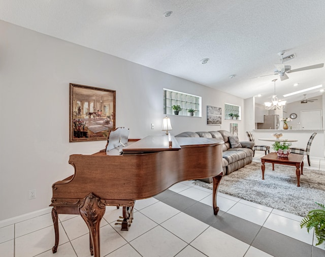 tiled living room featuring ceiling fan with notable chandelier, a textured ceiling, and vaulted ceiling