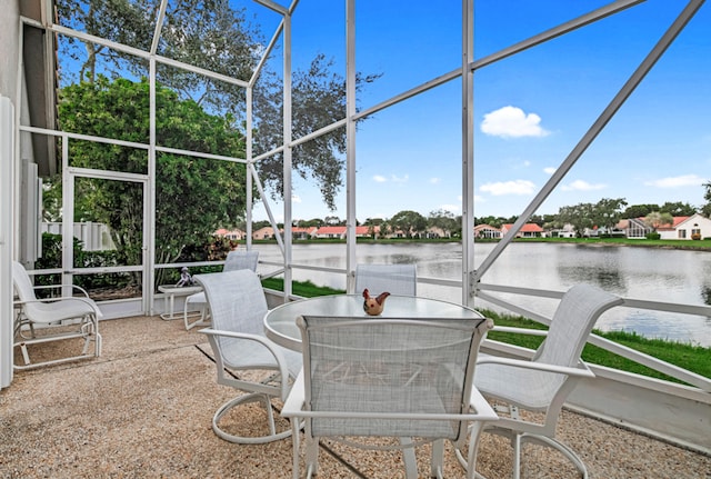 sunroom / solarium featuring a water view