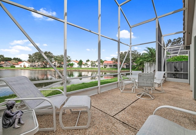 sunroom featuring a water view