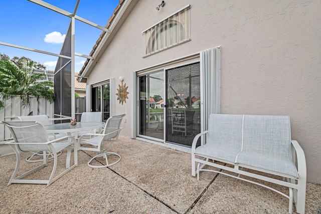 view of patio / terrace featuring glass enclosure