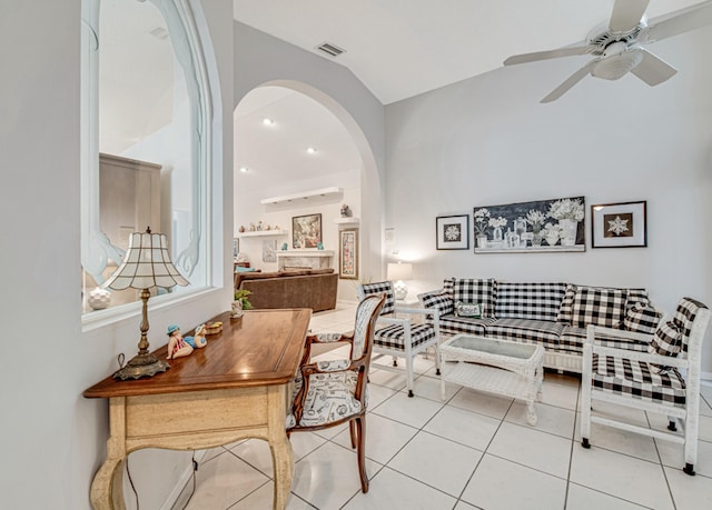 living room featuring vaulted ceiling, ceiling fan, and light tile patterned flooring