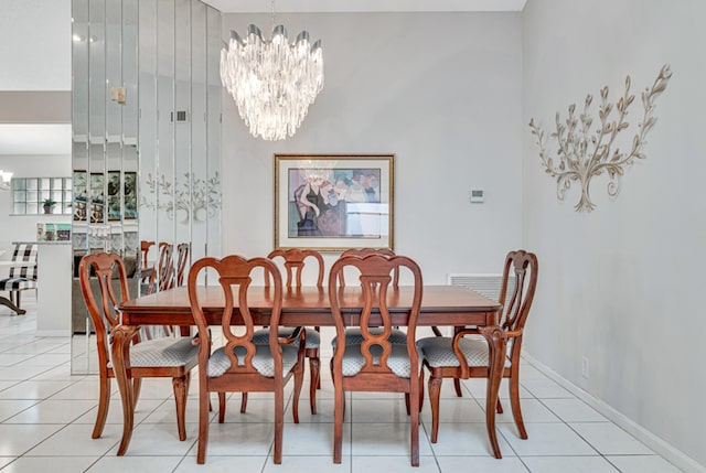 tiled dining area featuring a notable chandelier