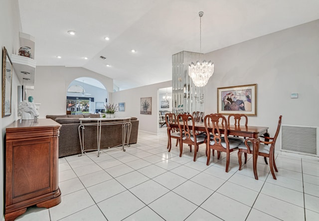 tiled dining space featuring a chandelier and lofted ceiling