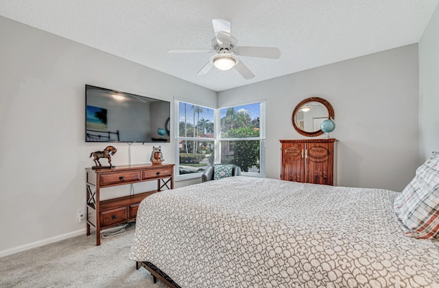 carpeted bedroom with a textured ceiling and ceiling fan