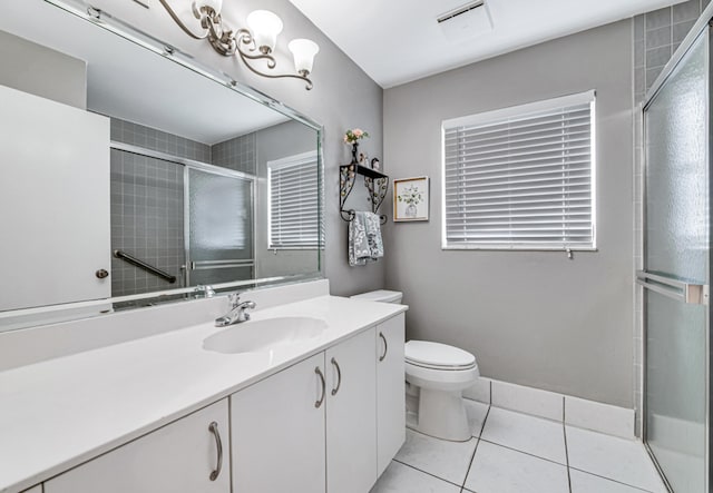 bathroom with tile patterned flooring, vanity, toilet, and walk in shower