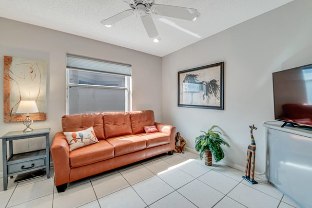 tiled living room featuring a textured ceiling and ceiling fan