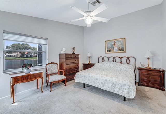 bedroom featuring light carpet and ceiling fan